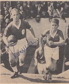 Ronnie Moran leading out the Liverpool team and a child fan